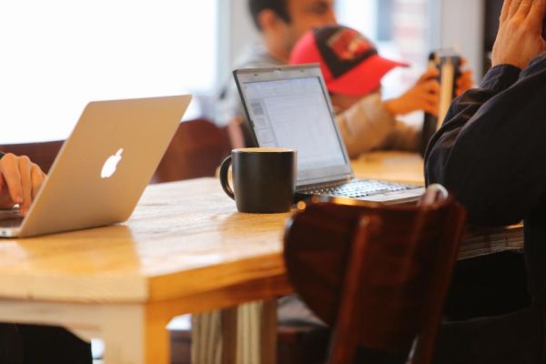 Laptop workspace used to review website content and support priorities
